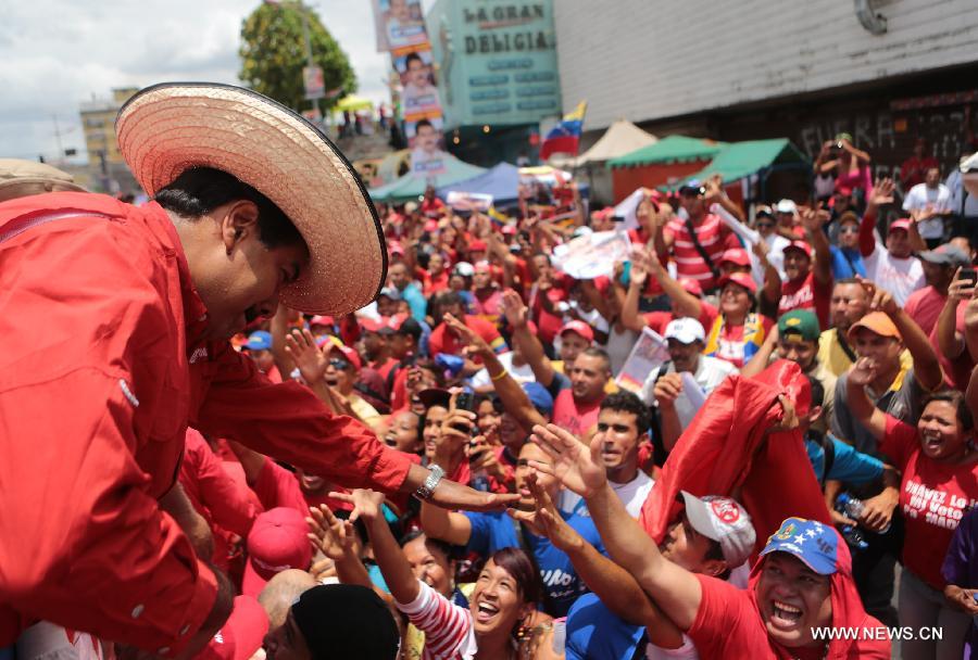 Image provided by Hugo Chavez Campaign Command shows Venezuelan Acting President and presidential candidate Nicolas Maduro (L) attending a campaign in Maturin, Monagas State, Venezuela, on April 8, 2013. Venezuela will held presidential elections on April 14. (Xinhua/Hugo Chavez Campaign Command) 