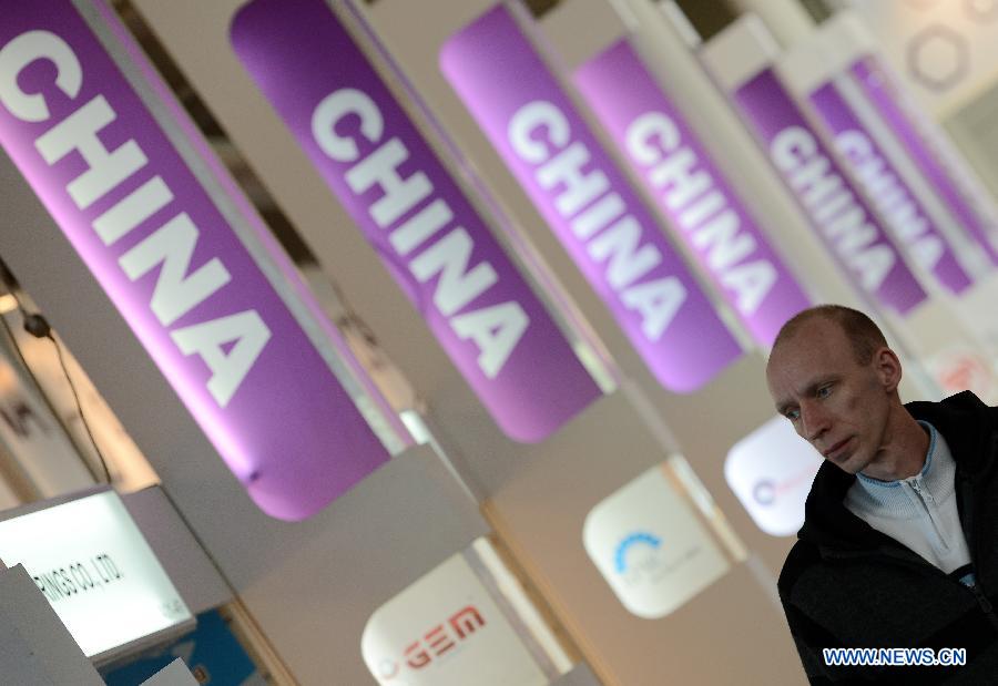 A visitor walks past China's exhibition area at the Hannover Industrial Expo in Hannover, Germany, on April 8, 2013. More than 730 Chinese companies participated in the world's largest and most influential industrial technology fair which kicked off on Monday. (Xinhua/Ma Ning)