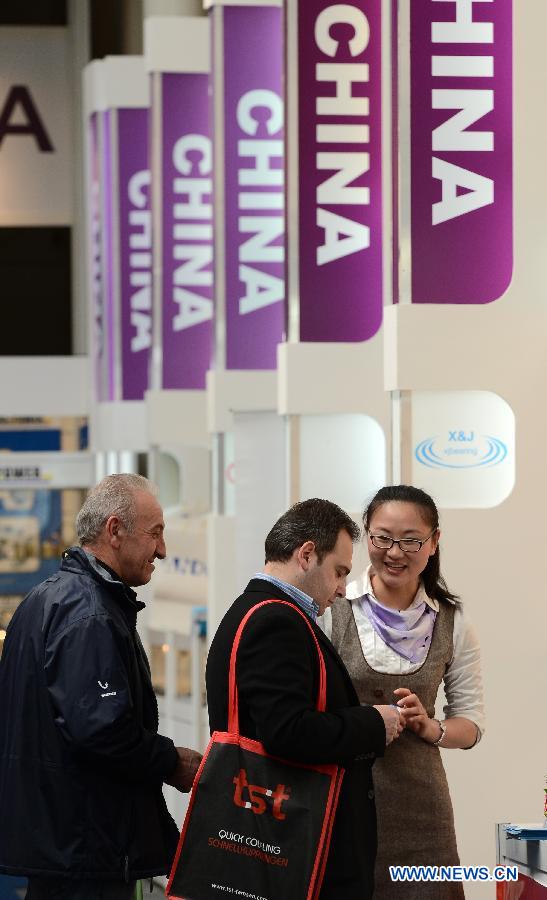 People visit China's exhibition area at the Hannover Industrial Expo in Hannover, Germany, on April 8, 2013. More than 730 Chinese companies participated in the world's largest and most influential industrial technology fair which kicked off on Monday. (Xinhua/Ma Ning)
