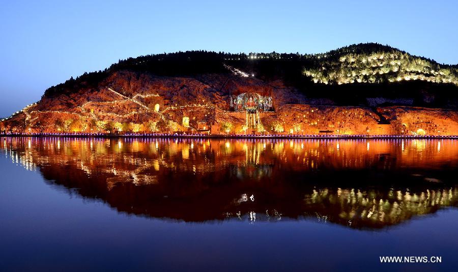 Photo taken on April 8, 2013 shows the night scenery in scenic area of Longmen Grottoes in Luoyang, central China's Henan Province. The night tour at Longmen Grottoes, a world cultural heritage site, has been opened to public since Monday. (Xinhua/Wang Song)