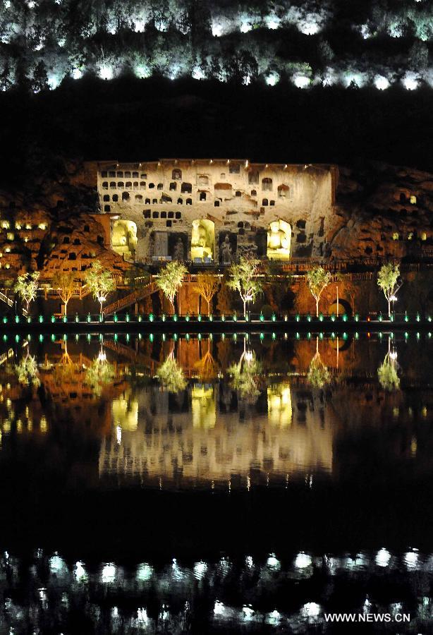 Photo taken on April 8, 2013 shows the night scenery of scenic area of Longmen Grottoes in Luoyang, central China's Henan Province. The night tour at Longmen Grottoes, a world cultural heritage site, has been opened to public since Monday. (Xinhua/Wang Song)