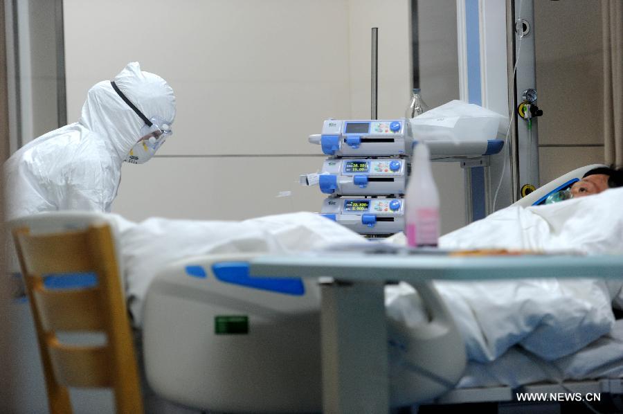 A medical worker gives medical care to a man infected with H7N9, a strain of avian influenza that had never been passed to humans before, at the People's Hospital of Bozhou City, east China's Anhui Province, April 8, 2013. The 55-year-old male patient, surnamed Li, once worked at a local live poultry stall. He was diagnosed positive of the H7N9 avian influenza virus on Sunday. As of 6 p.m. on Monday, China reported 24 cases of human infection with the lesser-known H7N9 bird flu virus, including 11 in Shanghai Municipality, eight in Jiangsu Province, three in Zhejiang Province and two in Anhui Province. Among the seven fatalities, five were in Shanghai and two in Zhejiang. (Xinhua/Liu Junxi) 