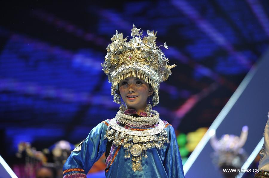 A competitor shows the costume of the Miao ethnic group during the final match of the 2013 Miss Tourism International (Guizhou) in Guiyang, capital of southwest China's Guizhou Province, April 9, 2013. The final match, with the participation of 31 competitors, closed here Tuesday. (Xinhua/Ou Dongqu) 