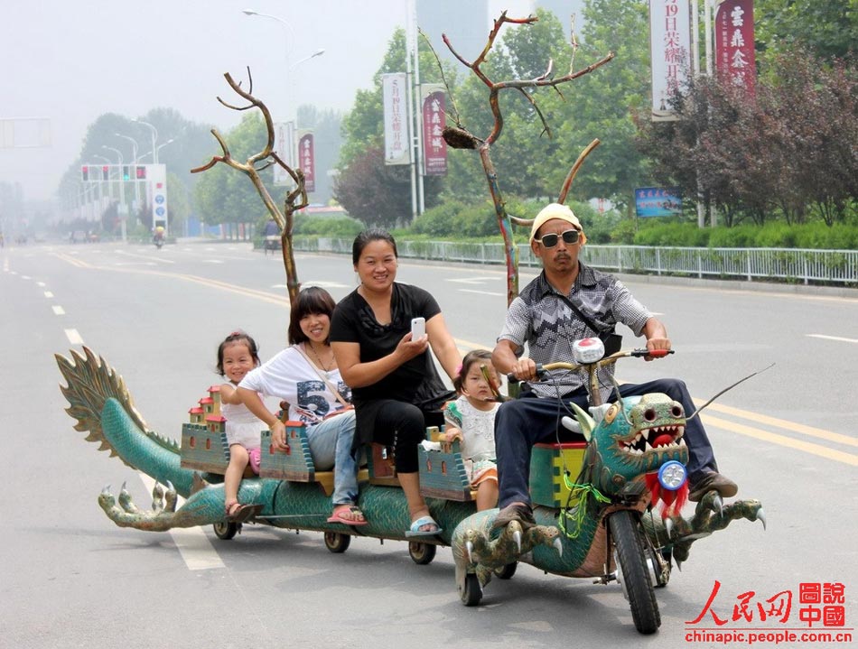 Local residents ride a "dragon-shaped vehicle" in Zhoukou, Henan province on Aug 15, 2012. 