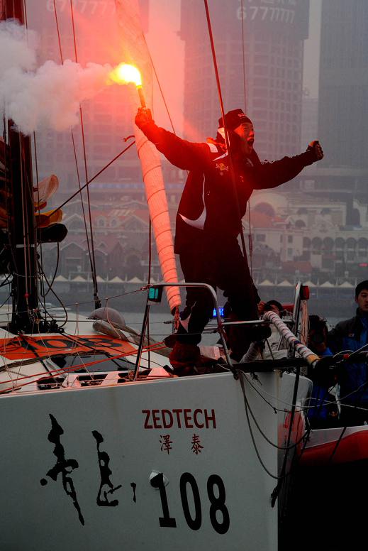 China's Guo Chuan celebrates after returning home in Qingdao, east China's Shandong province, April 5, 2013. Guo becomes the first Chinese to successfully circumnavigate the globe singlehanded. Aboard his Class40 yacht, 48-year-old Guo travelled about 21,600 nautical miles in 138 days before he returned to his hometown of Qingdao, where he set off on Nov. 18 last year. (Xinhua/Li Ziheng) 