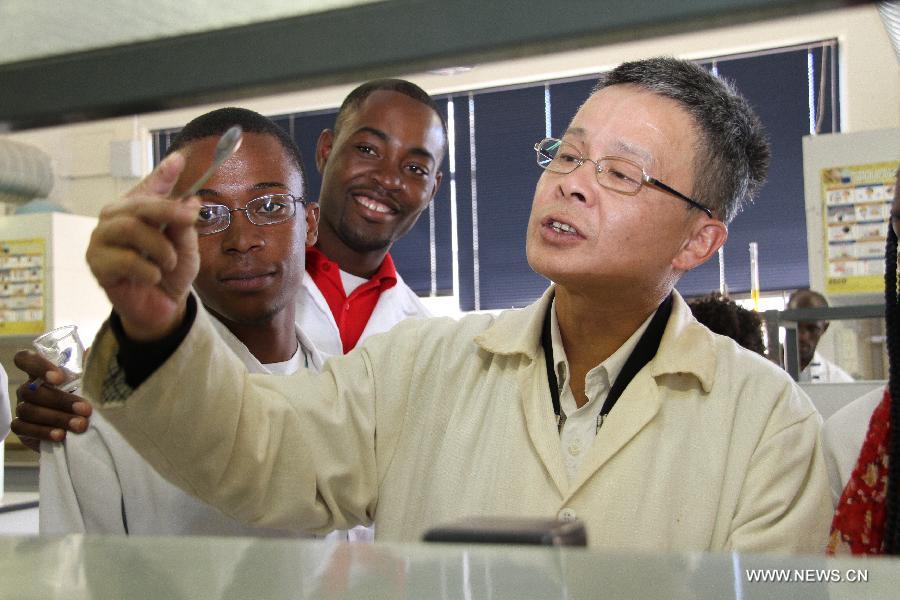 Chinese teacher Song Wei instructs his students during a chemistry experiment at University of Namibia in Windhoek, Namibia, April 8, 2013. To fulfill the agreement on higher-education cooperation between China and Namibia, China's universities started dispatching teachers to work at University of Namibia since mid-1990s. The Chinese teachers have since gained respect and good reputation because of their diligent work and serious attitude in academics. They have made remarkable contributions to the cultivation of local talents and the friendship between China and Namibia. (Xinhua/Gao Lei) 