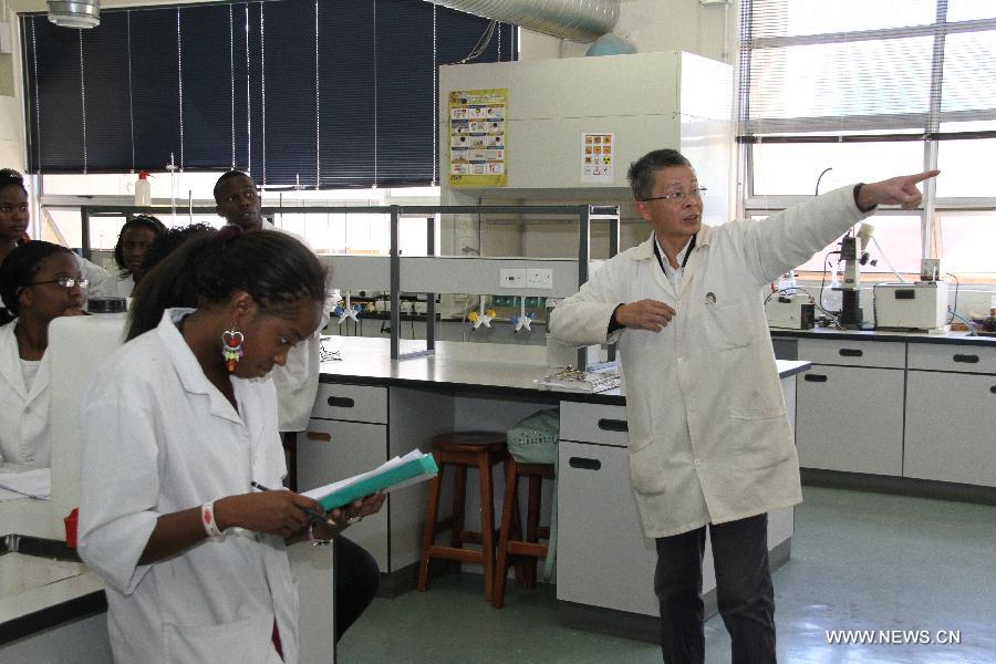 Chinese teacher Song Wei instructs his students during a chemistry experiment at University of Namibia in Windhoek, Namibia, April 8, 2013. To fulfill the agreement on higher-education cooperation between China and Namibia, China's universities started dispatching teachers to work at University of Namibia since mid-1990s. The Chinese teachers have since gained respect and good reputation because of their diligent work and serious attitude in academics. They have made remarkable contributions to the cultivation of local talents and the friendship between China and Namibia. (Xinhua/Gao Lei) 