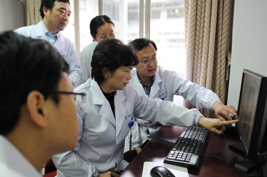 Li Lanjuan (2nd R, front), an academician of Chinese Engineering Academy and director of the State Key Laboratory for Diagnosis and Treatment of Infectious Diseases, discusses a H7N9-contracted patient's condition with her colleagues in Hangzhou, capital of east China's Zhejiang Province, April 10, 2013. As of Tuesday afternoon, China had reported a total of 28 H7N9 cases in Shanghai municipality and the provinces of Jiangsu, Anhui and Zhejiang, including nine fatalities, according to the National Health and Family Planning Commission. (Xinhua/Ju Huanzong)