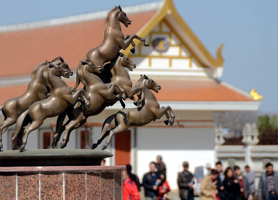 Tourists visit the Thai-style Buddha hall at the Baima Temple, or the White Horse Temple, in Luoyang City, Central China's Henan Province, April 10, 2013. Visitors can see Buddha halls with different styles of foreign countries at the Baima Temple, the oldest Buddhist temple in China.(Xinhua/Wang Song)