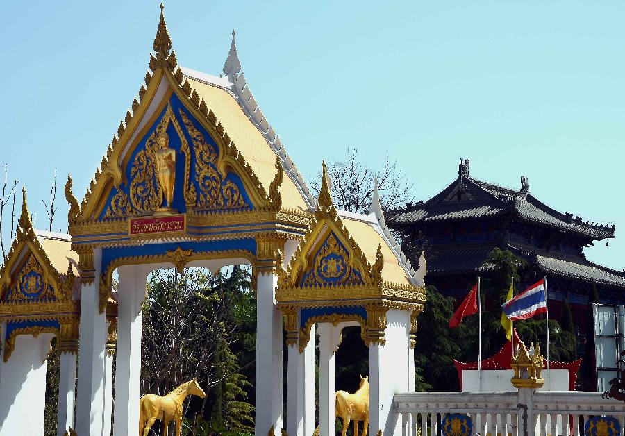 Photo taken on April 10, 2013 shows the gate of Thai-style Buddha hall (front) at the Baima Temple, or the White Horse Temple, in Luoyang City, Central China's Henan Province. Visitors can see Buddha halls with different styles of foreign countries at the Baima Temple, the oldest Buddhist temple in China.(Xinhua/Wang Song)