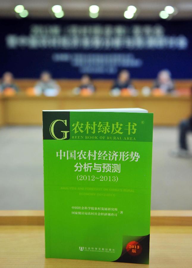 Photo taken on April 10, 2013 shows the cover of the "Green Book of Rural Area: Analysis and Forecast on China's Rural Economy (2012-2013)" at a press conference in Beijing, capital of China. The book was released on Wednesday. (Xinhua/Chen Yehua)