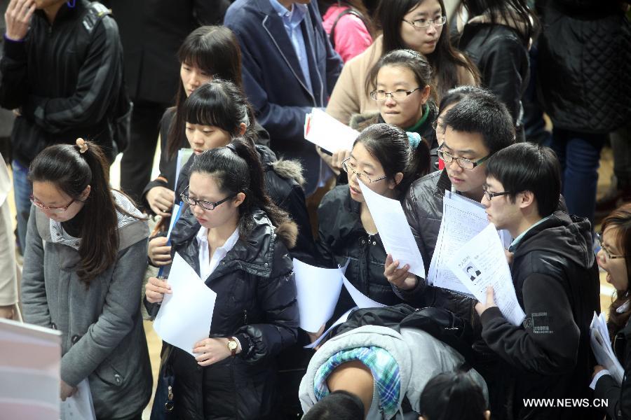 Job hunters take part in a job fair at the Tianjin University of Finance and Economics in Tianjin, north China, April 10, 2013. The job fair attracted 225 enterprises and institutions, providing 4,700 job vacancies for college graduates. (Xinhua/Liu Dongyue)  