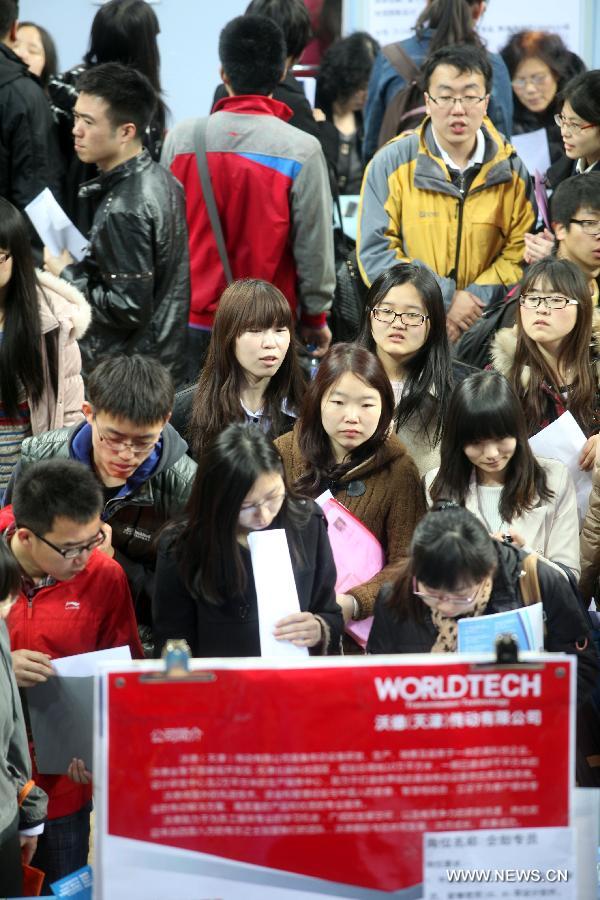 Job hunters take part in a job fair at the Tianjin University of Finance and Economics in Tianjin, north China, April 10, 2013. The job fair attracted 225 enterprises and institutions, providing 4,700 job vacancies for college graduates. (Xinhua/Liu Dongyue)  