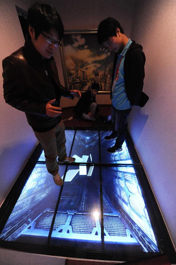 A staff member tests a device at the Believe It Or Not Museum in Shanghai, east China, April 10, 2013. Believe It Or Not Museum, as a world renowned tourism project, attracted numbers of visitors around the globe with its unbelievable and amazing devices and scenes. The museum in Shanghai is expected to open to visitors in late April. (Xinhua/Lai Xinlin) 