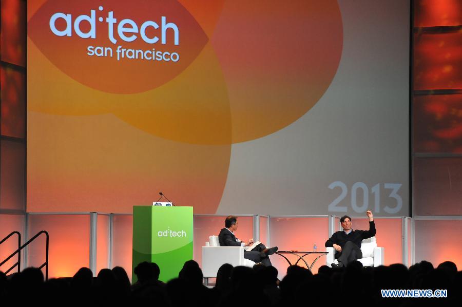Tim Armstong (R), CEO of AOL, delivers a keynote speech during the opening ceremony of the "ad:tech San Francisco 2013" in San Francisco, the United States, April 9, 2013. The two-day exposition has over 30 lectures and about 200 booths for international advertisement companies and clients. (Xinhua/Liu Yilin) 