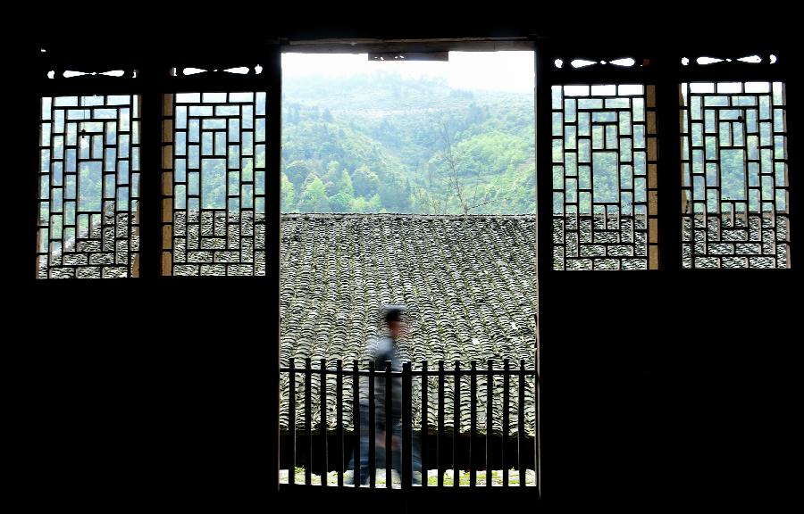 A villager walks past a stilted building in Lianghekou Village in Enshi, central China's Hubei Province, April 10, 2013. Stilted buildings of Tujia ethnic group, mainly seen in central China's Hunan and Hubei Province, is a gem of Chinese residence. Lianghekou Village is one of the best reserved areas for Tujia stilted buildings. (Xinhua/Song Wen) 