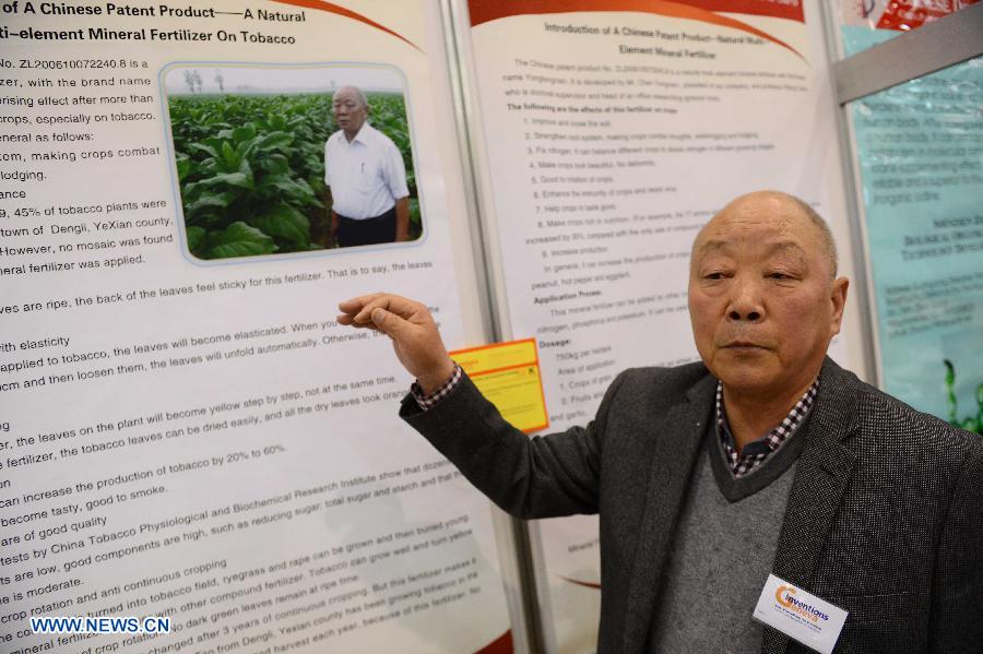 Chen Yongnian, a representative of a fertilizer company from Pingdingshan City of China's Henan Province, introduces natural multi-element mineral fertilizer on the 41st International Exhibition of Inventions of Geneva, in Palexpo of Geneva, Switzerland, April 10, 2013. Some 50 Chinese participants came to the exhibition to display their 23 objects of invention. (Xinhua/Wang Siwei) 