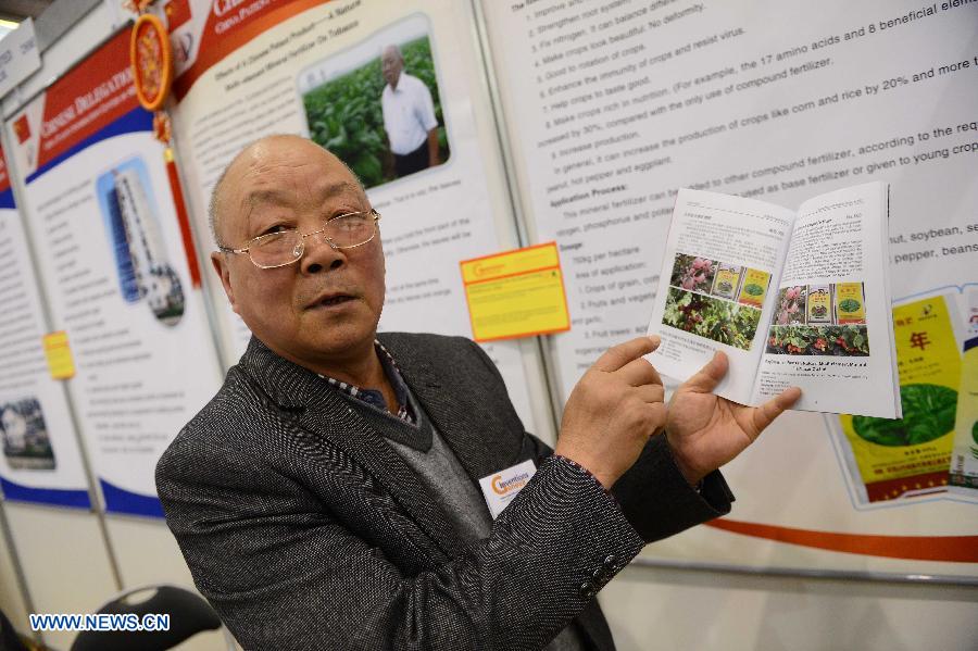 Chen Yongnian, a representative of a fertilizer company from Pingdingshan City of China's Henan Province, introduces natural multi-element mineral fertilizer on the 41st International Exhibition of Inventions of Geneva, in Palexpo of Geneva, Switzerland, April 10, 2013. Some 50 Chinese participants came to the exhibition to display their 23 objects of invention. (Xinhua/Wang Siwei) 