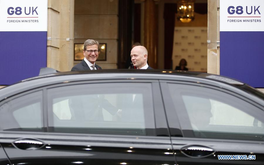 British Foreign Secretary William Hague welcomes German Foreign Minister Guido Westerwelle (L) at the G8 Foreign Ministers Meeting at Lancaster Houseon in London, Britain, on April 11, 2013. (Xinhua/Wang Lili)