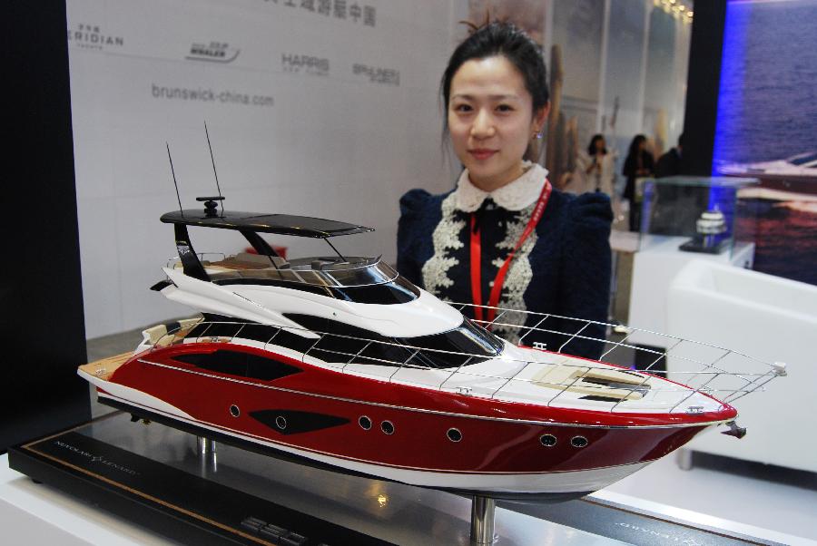 A staff member presents a yacht model during the 18th China (Shanghai) International Boat Show (CIBS) at the Shanghai World Expo Exhibition & Convention Center in Shanghai, east China, April 11, 2013. A total of 550 real boats from 500 exhibitors were displayed at the four-day-long CIBS that kicked off on Thursday. (Xinhua/Ma Tian'en) 
