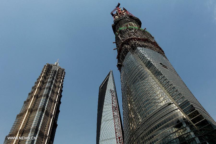 Photo taken on April 11, 2013 shows the Shanghai Tower (R) under construction in east China's Shanghai Municipality. The height of the Shanghai Tower, which is still under construction, reached 501.3 meters Thursday, surpassing the neighbouring Jinmao Tower and the World Financial Center. The designed height of the Shanghai Tower will be 632 meters, the tallest skyscraper in China. (Xinhua/Pei Xin) 