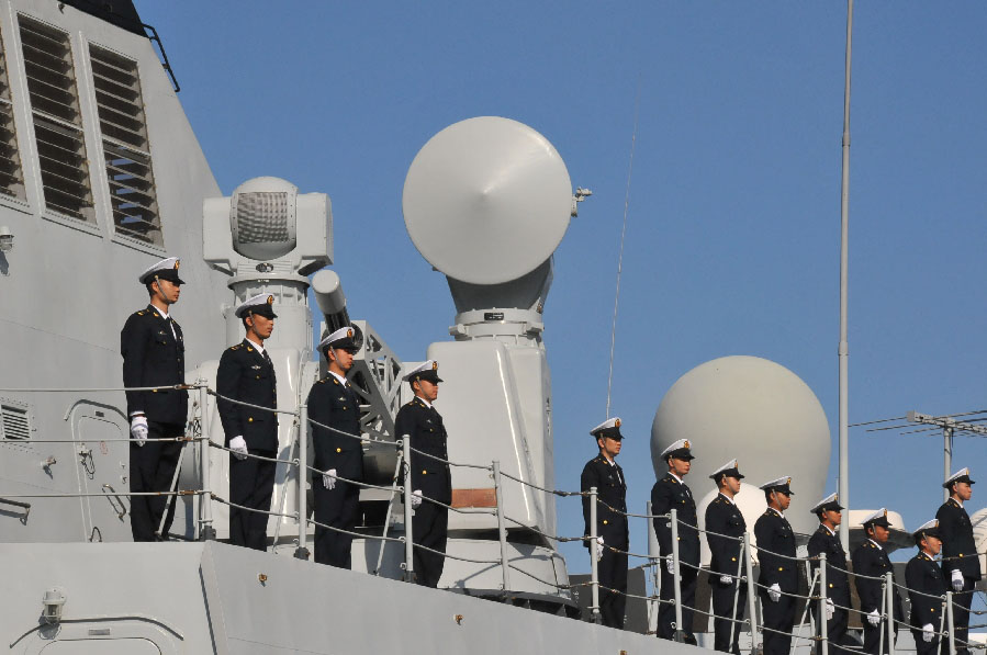 The 13th escort taskforce under the Navy of the Chinese People's Liberation Army (PLA), which just completed the escort mission in the Gulf of Aden and the waters off the Somali coast, arrived at the Casablanca Port of Morocco on April 9, 2013, starting its five-day-long visit to the country. This is the first time for a Chinese naval fleet to visit Morocco. The picture shows the officers and men of the "Huangshan" warship of the 13th Chinese naval escort taskforce are lining up on the bridge in the Casablanca Port of Morocco. (Xinhua/Linfeng)