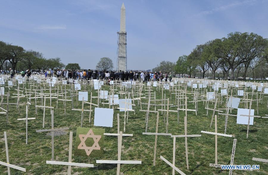 Grave markers are erected in a mock cemetery to honor the victims of gun violence during a 24-hour vigil on the National Mall in Washington D.C., capital of the United States, April 11, 2013. The U.S. Senate on Thursday voted to open debate on gun control measures advocated by President Barack Obama and mostly Democratic lawmakers, clearing the first hurdle for relevant legislation. (Xinhua/Wang Yiou) 