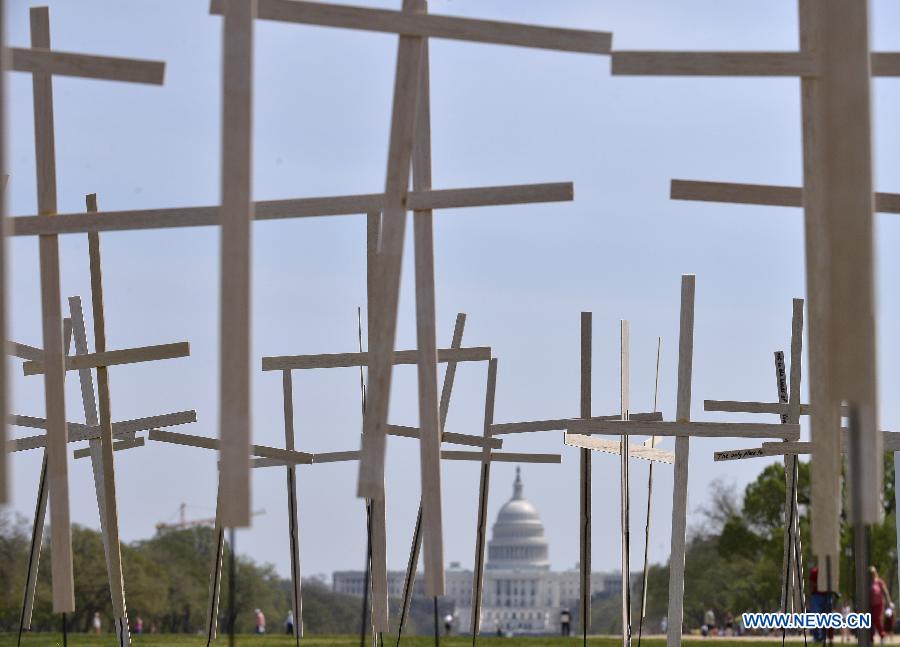 Grave markers are erected in a mock cemetery to honor the victims of gun violence during a 24-hour vigil on the National Mall in Washington D.C., capital of the United States, April 11, 2013. The U.S. Senate on Thursday voted to open debate on gun control measures advocated by President Barack Obama and mostly Democratic lawmakers, clearing the first hurdle for relevant legislation. (Xinhua/Wang Yiou)