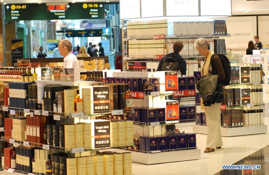 Travellers walk at a World Duty Free store at Vancouver International Airport (YVR) in Vancouver, Canada, April 10, 2013. YVR was named Best Airport in North America at the Skytrax World Airport Awards in Geneva, Switzerland on April 10. YVR is rated 8th overall worldwide and is the only North American airport included in the top ten. (Xinhua/Sergei Bachlakov)