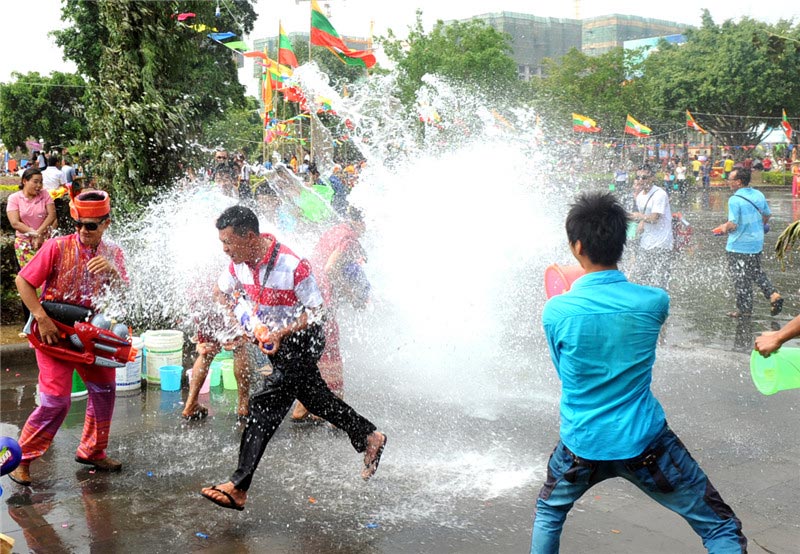 Men use homemade old style telephones during the Water Splashing Festival celebrations in Dehong Dai and Jingpo autonomous prefecture in Yunnan on April 11, 2013. (Xinhua)