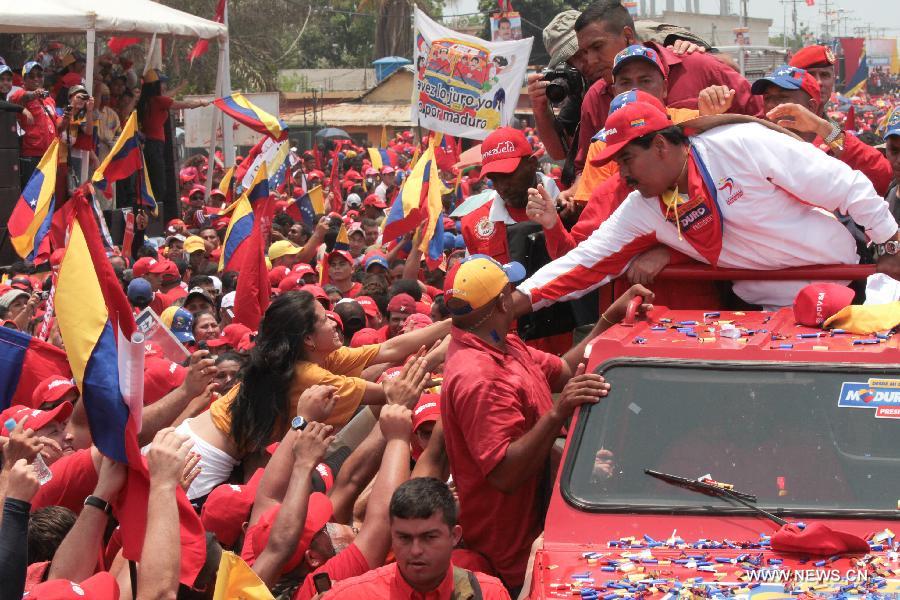 Image provided by the Hugo Chavez Comando shows Venezuela's Acting President and Presidential Candidate Nicolas Maduro (R) shaking hands with his supporters upon his arrival to a campaign event, in the city of Cabimas, state of Zulia, Venezuela, on April 11, 2013. Venezuela will hold the Presidential election on April 14. Nicolas Maduro closed his political campaign in the city of Caracas, capital of Venezuela, on Thursday evening. (Xinhua/Hugo Chavez Comando) 