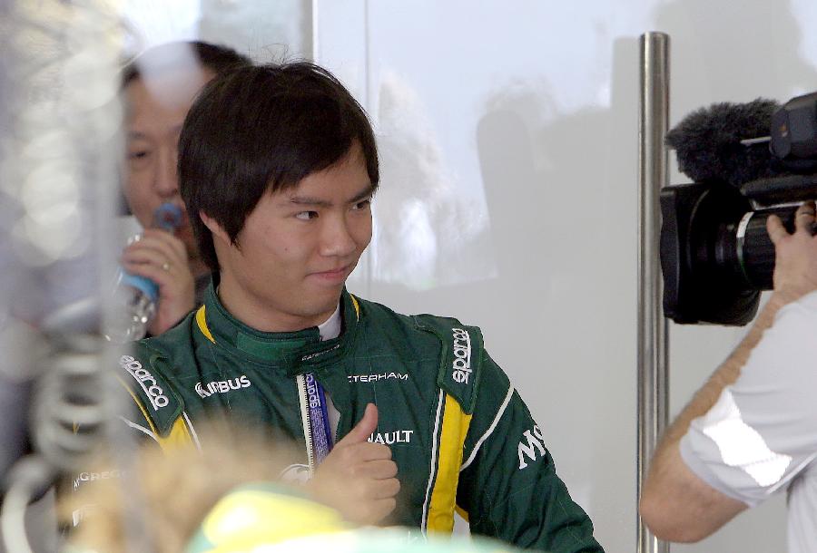 Caterham reserve driver Ma Qinghua reacts in front of a camera during the first practice session of the Chinese F1 Grand Prix at the Shanghai International circuit, in Shanghai, east China, on April 12, 2013. (Xinhua/Fan Jun)