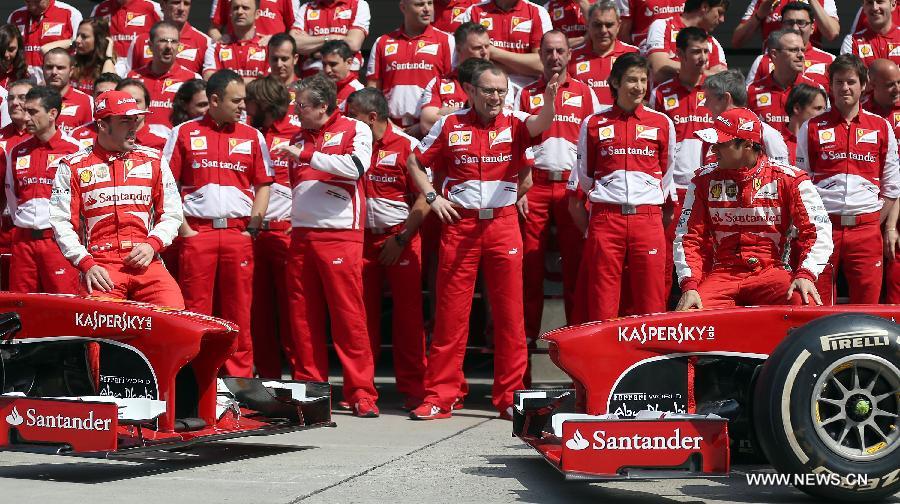 Ferrari drivers Fernando Alonso (Front L) and Felipe Massa (Front R) pose with their team for a group photo before the first practice session of the Chinese F1 Grand Prix at the Shanghai International circuit, in Shanghai, east China, on April 12, 2013. (Xinhua/Li Ming)