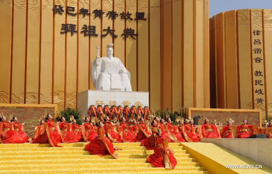 Performers dance in a ceremony paying homage to Huang Di, or Yellow Emperor, who is considered as the ancestor of all Chinese people, in Xinzheng City, central China's Henan Province, April 12, 2013. (Xinhua/Li Bo)