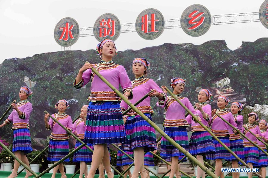 Women of Dai ethnic group perform during a folk custom and culture festival marking the "San Yue San" (the third day of the third lunar month in Chinese Calendar) in Shizong County, southwest China's Yunnan Province, April 12, 2013. The festival, attracting tens of thousands of local residents and tourists from both at home and abroad, was held here Friday. (Xinhua/Yang Zongyou)