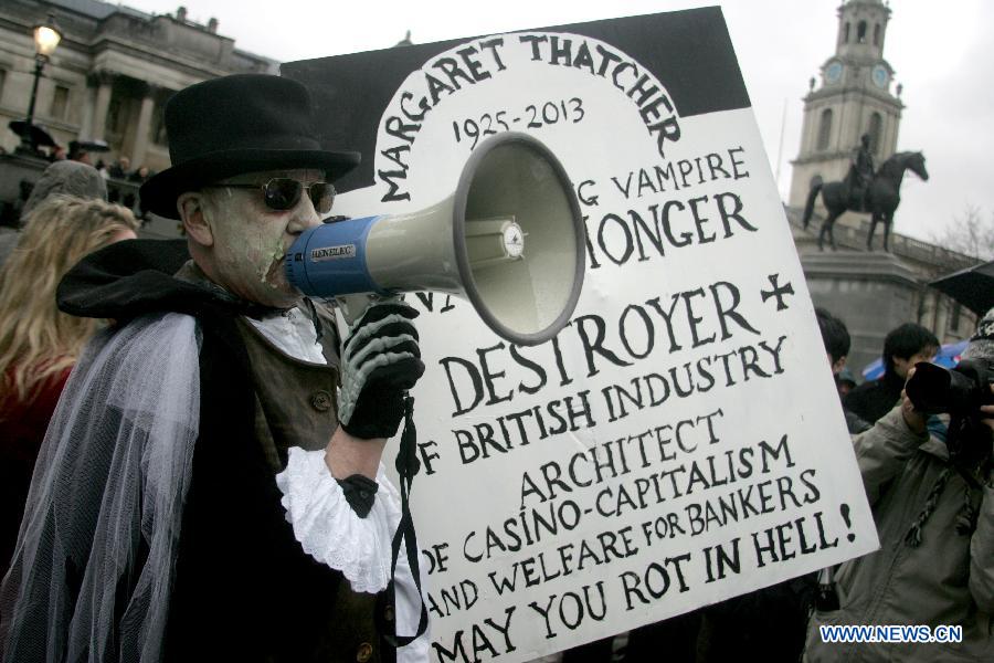A protester holds a placard during a party marking former British Prime Minister Margaret Thatcher's death in central London's Trafalgar square, on April 13, 2013. Parties staged by opponents of Margaret Thatcher to celebrate her death took place in several locations across the UK on Saturday. (Xinhua/Bimal Gautam) 