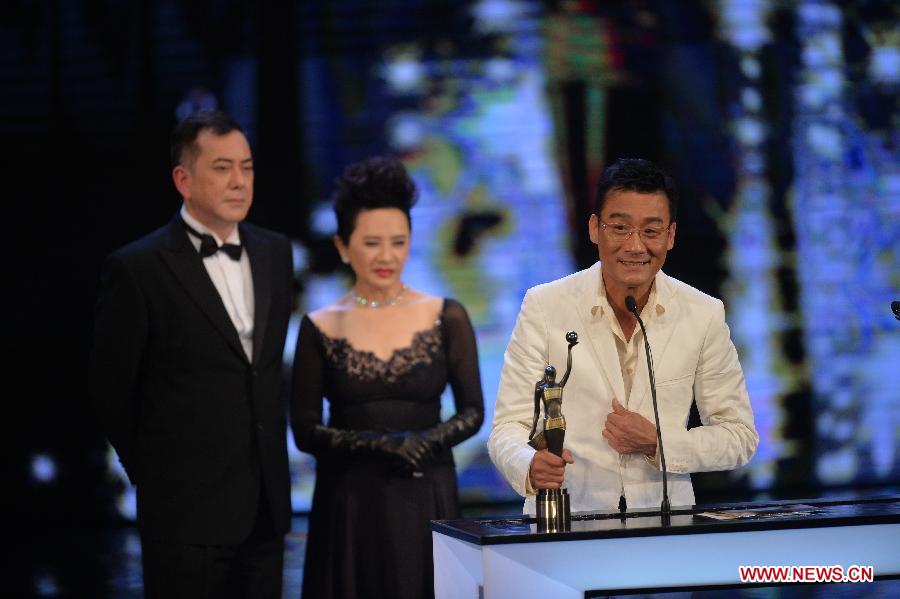 Actor Tony Leung (R) receives the Best Actor award for his movie "Cold War" at the presentation ceremony of the 32nd Hong Kong Film Awards in south China's Hong Kong, April 13, 2013. (Xinhua/Chen Xiaowei)