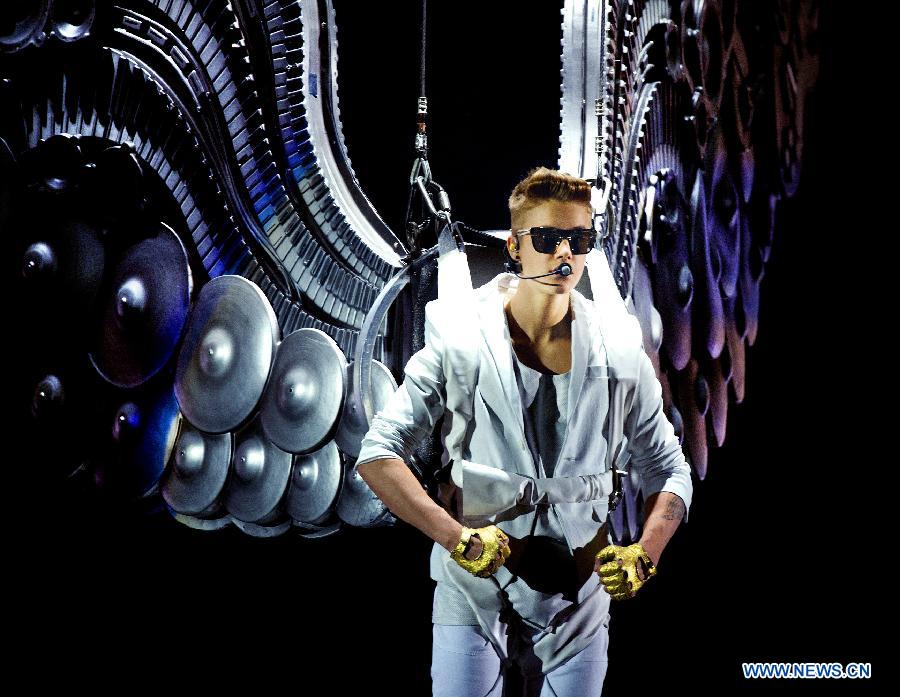 Pop singer Justin Bieber sings during his vocal concert in the gelredome in Arnhem, the Netherlands, April 13, 2013.(Xinhua/Robin Utrecht) 