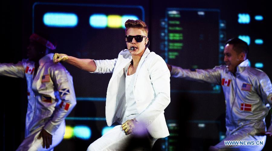 Pop singer Justin Bieber sings during his vocal concert in the gelredome in Arnhem, the Netherlands, April 13, 2013.(Xinhua/Robin Utrecht) 