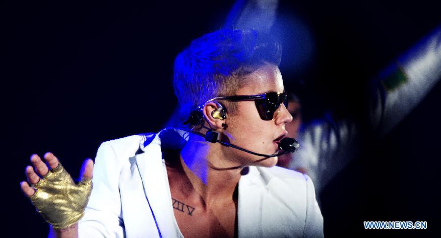 Pop singer Justin Bieber sings during his vocal concert in the gelredome in Arnhem, the Netherlands, April 13, 2013.(Xinhua/Robin Utrecht) 