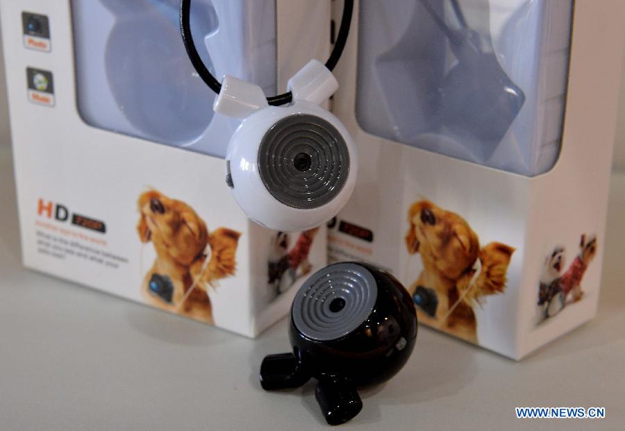 Photo taken on April 13, 2013 shows micro digital cameras which can take record of pets' walking track displayed at the 10th Hong Kong Electronics Fair (Spring Edition) in south China's Hong Kong. The four-day fair, which kicked off on Saturday, attracted 3,250 enterprises from 24 countries and regions. (Xinhua/Chen Xiaowei)