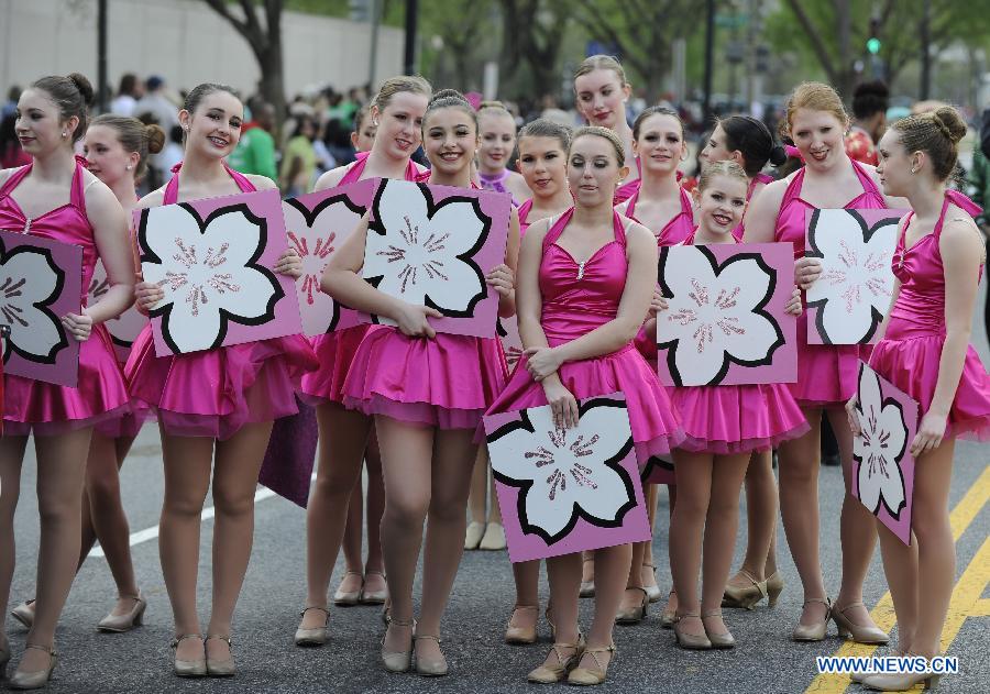 Girls wait to perform during the annual National Cherry Blossom Festival Parade along Constitution Avenue in Washington D.C., capital of the United States, April 13, 2013. The parade is one of the US capital's biggest public events of the year, drawing about 100,000 spectators from around the world. (Xinhua/Wang Yiou) 