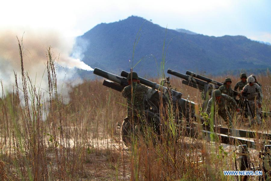 Filipino soldiers fire a 105mm Howitzer during a live fire drill as part of a joint military exercise in Tarlac Province, the Philippines, April 12, 2013. The Philippines and the U.S. held their 29th annual joint military exercise with at least 8,000 American and Filipino soldiers participating in the training. The joint military exercise, more known as Balikatan, which means "shoulder-to-shoulder" in Filipino, is held from April 5 to 17. (Xinhua/Rouelle Umali)
