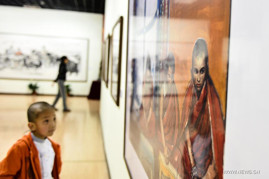 A child views paintings at an exhibition commemorating the third anniversary of the Yushu earthquake, at the Qinghai Provincial Museum in Xining, capital of northwest China's Qinghai Province, April 14, 2013. A 7.1-magnitude earthquake hit Yushu on April 14, 2010, leaving 2,698 dead and over 12,000 injured.(Xinhua/Wu Gang) 