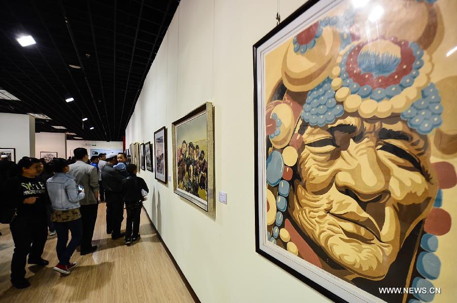 Visitors watch paintings at an exhibition commemorating the third anniversary of the Yushu earthquake, at the Qinghai Provincial Museum in Xining, capital of northwest China's Qinghai Province, April 14, 2013. A 7.1-magnitude earthquake hit Yushu on April 14, 2010, leaving 2,698 dead and over 12,000 injured.(Xinhua/Wu Gang)  