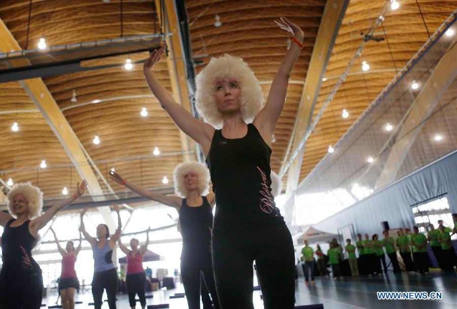 Ladies participate in a marathon exercise fund raising event at the Richmond Oval in Richmond, Canada, on April 13, 2013. Over 300 women take part in a marathon seven-hour dance at the Bust a Move event to raise fund for BC Cancer Foundation in order to help fighting against the breast cancer. (Xinhua/Liang Sen)