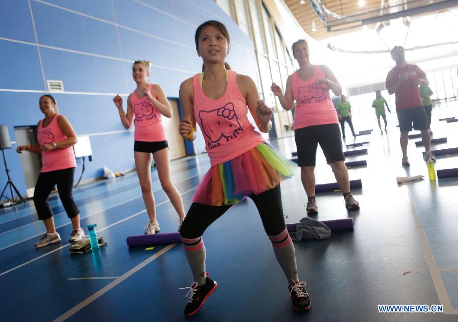 Ladies participate in a marathon exercise fund raising event at the Richmond Oval in Richmond, Canada, on April 13, 2013. Over 300 women take part in a marathon seven-hour dance at the Bust a Move event to raise fund for BC Cancer Foundation in order to help fighting against the breast cancer. (Xinhua/Liang Sen)