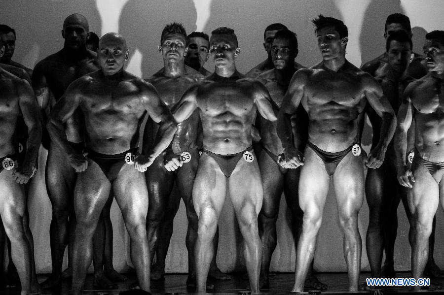 Bodybuilders participate in a bodybuilding competition called "Mr. Colombia" held in Bogota, capital of Colombia, on April 13, 2013. (Xinhua/Jhon Paz)