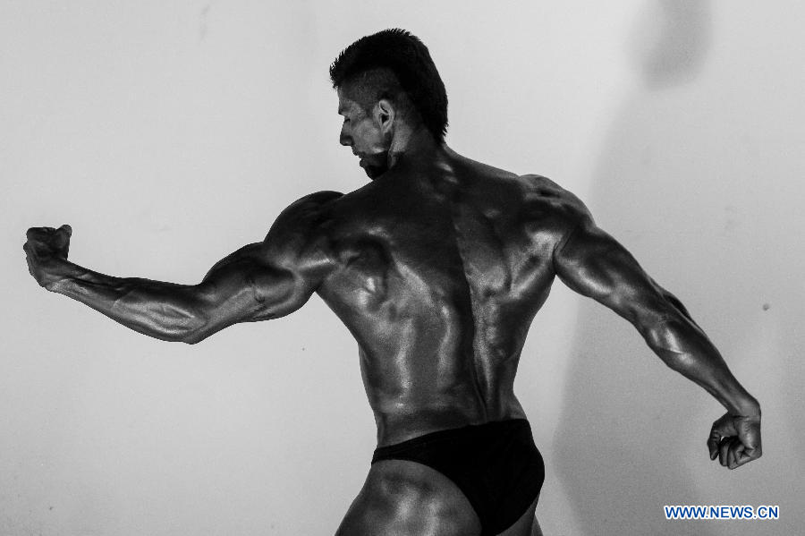 A bodybuilder participates in a bodybuilding competition called "Mr. Colombia" held in Bogota, capital of Colombia, on April 13, 2013. (Xinhua/Jhon Paz)