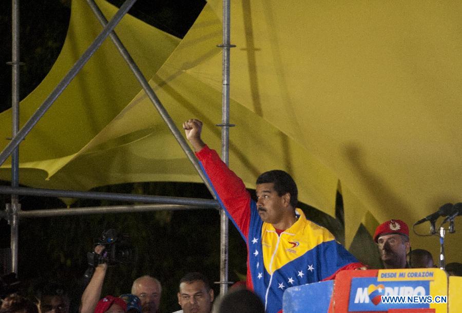 Venezuelan acting President Nicolas Maduro celebrates his victory in Caracas, capital of Venezuela, on April 14, 2013. Venezuelan Acting President Nicolas Maduro narrowly won the presidential election with 50.66 percent of the votes, National Electoral Council's President Tibisay Lucena said on Sunday. (Xinhua/Mauricio Valenzuela) 